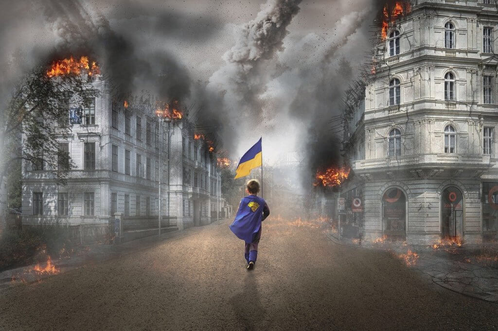 Grafika przedstawia chłopca kroczącego przez płonące miasto z flagą Ukrainy w ręku